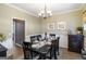 Elegant dining room featuring a dark wood table with seating for six and decorative wall art at 419 Tea Rose N Ln, Stockbridge, GA 30281