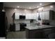 Well-equipped kitchen boasts granite countertops, stainless appliances, and sleek black and white color scheme at 419 Tea Rose N Ln, Stockbridge, GA 30281