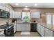 Bright kitchen with white cabinets, granite countertops, subway tile backsplash, and stainless steel appliances at 419 Tea Rose N Ln, Stockbridge, GA 30281