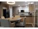Modern kitchen with white cabinets, granite countertops, and an adjacent dining area at 419 Tea Rose N Ln, Stockbridge, GA 30281