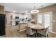 Modern kitchen with white cabinets, stainless steel appliances, granite countertops, and an adjacent dining area at 419 Tea Rose N Ln, Stockbridge, GA 30281