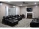 Spacious living room with plush seating, fireplace, and large window with natural light at 419 Tea Rose N Ln, Stockbridge, GA 30281