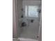 Walk-in shower with marble tile surround, glass enclosure, and built-in shelving at 419 Tea Rose N Ln, Stockbridge, GA 30281