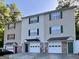 Multi-Gathering townhouse with attached garages, vinyl siding, and colorful accent doors and shutters at 33 Corinth Rd, Cartersville, GA 30121