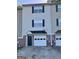 Close up on a townhouse, highlighting the brick accents and garage door at 33 Corinth Rd, Cartersville, GA 30121