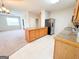 Bright kitchen with island, tile floors, and stainless steel refrigerator at 33 Corinth Rd, Cartersville, GA 30121