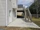 Backyard patio with stairs leading to the deck above; the perfect layout for outdoor entertaining at 6281 Vinings Vintage Dr, Mableton, GA 30126