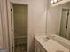 Bathroom with a double sink, large mirror, and a view into the shower/tub space at 6281 Vinings Vintage Dr, Mableton, GA 30126