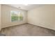 A bedroom with beige walls and carpet with large windows bringing in natural light at 6281 Vinings Vintage Dr, Mableton, GA 30126