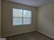 Cozy bedroom with neutral walls, carpet, and a window view of the outdoors at 6281 Vinings Vintage Dr, Mableton, GA 30126