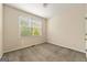 Neutral bedroom with carpet, a window, baseboards, and a door at 6281 Vinings Vintage Dr, Mableton, GA 30126