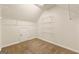 Walk-in closet featuring neutral carpet, shelving and lighting at 6281 Vinings Vintage Dr, Mableton, GA 30126