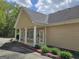 Tan siding building with white trim, pillars and a concrete parking lot in a commercial space at 6281 Vinings Vintage Dr, Mableton, GA 30126