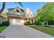 Traditional two-story home with brick accents, two-car garage, and well-maintained landscaping at 6281 Vinings Vintage Dr, Mableton, GA 30126