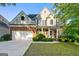Charming two-story brick and siding home with manicured lawn and attached two-car garage at 6281 Vinings Vintage Dr, Mableton, GA 30126