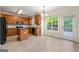 A well-lit kitchen features wood cabinets, black appliances, an island, and a door leading to a deck at 6281 Vinings Vintage Dr, Mableton, GA 30126