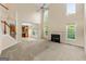Spacious living room with tall windows, a fireplace, and a view to the kitchen at 6281 Vinings Vintage Dr, Mableton, GA 30126