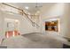 Open-concept living area with staircase, high ceilings, and seamless flow to kitchen at 6281 Vinings Vintage Dr, Mableton, GA 30126