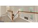 A carpeted staircase with white banisters ascends to a second-floor landing with many windows at 6281 Vinings Vintage Dr, Mableton, GA 30126
