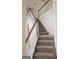 Carpeted staircase with decorative wood trim, leading to the upper level at 6281 Vinings Vintage Dr, Mableton, GA 30126