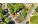 Overhead view of a well-maintained home surrounded by lush trees, showcasing its inviting curb appeal and peaceful setting at 310 Hamdon Kells, Peachtree City, GA 30269