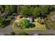 Drone image shows house in a yard surrounded by trees, with a yellow border defining property lines, on a residential street at 310 Hamdon Kells, Peachtree City, GA 30269