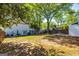 Expansive backyard featuring a wooden deck, lush lawn, mature trees, and outdoor seating, perfect for entertaining and relaxation at 310 Hamdon Kells, Peachtree City, GA 30269