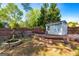Backyard featuring a shed, fire pit, and wooden deck at 310 Hamdon Kells, Peachtree City, GA 30269