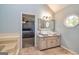 Primary bathroom with double sinks and an open doorway to the bedroom at 310 Hamdon Kells, Peachtree City, GA 30269