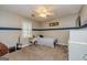 Cozy bedroom features a bed, accent wall, ceiling fan, and guitar at 310 Hamdon Kells, Peachtree City, GA 30269