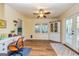 Bright bonus room featuring a desk, built-in shelves, and access to the outdoors at 310 Hamdon Kells, Peachtree City, GA 30269