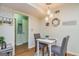 Cozy dining area with modern chandelier and access to the kitchen and hallway at 310 Hamdon Kells, Peachtree City, GA 30269