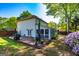 Charming home exterior with a spacious deck, screened porch, verdant lawn, and colorful blooming flowers, perfect for outdoor living at 310 Hamdon Kells, Peachtree City, GA 30269
