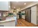 This kitchen boasts wood floors, stainless steel appliances, and bright white cabinets at 310 Hamdon Kells, Peachtree City, GA 30269