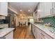 Bright kitchen features stainless steel appliances, granite countertops, and backsplash at 310 Hamdon Kells, Peachtree City, GA 30269