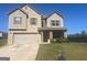 Charming two-story home with a brick and siding exterior, attached garage, and well-manicured lawn at 375 Madison Grace Ave, Mcdonough, GA 30252