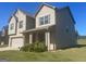 Attractive two-story home featuring a blend of brick and siding, an attached garage, and a welcoming front porch at 375 Madison Grace Ave, Mcdonough, GA 30252
