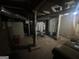 A basement area featuring supporting beams, concrete foundation, with furniture at 4582 Hendrix Dr, Forest Park, GA 30297