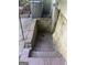 Basement entrance with brick steps leading down to door. Washer and dryer visible at 4582 Hendrix Dr, Forest Park, GA 30297