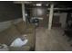 Basement space featuring concrete foundation, support beams, couch, grill, and other various personal items at 4582 Hendrix Dr, Forest Park, GA 30297