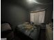 Picture of a bedroom with a bed, side table, and soft lighting at 4582 Hendrix Dr, Forest Park, GA 30297