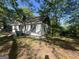 An exterior view of a cozy home surrounded by lush greenery and a well-maintained lawn at 4582 Hendrix Dr, Forest Park, GA 30297