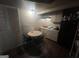 A functional kitchen area with essential appliances and a small dining table at 4582 Hendrix Dr, Forest Park, GA 30297