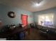 Wide shot of a living room, with tables, chairs, decor, and natural light at 4582 Hendrix Dr, Forest Park, GA 30297