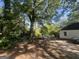 Side/Back view of home with wooded yard and a black roof at 4582 Hendrix Dr, Forest Park, GA 30297