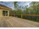 Spacious back deck with wooden railings and a sliding glass door to a home surrounded by lush greenery at 345 Phillips Dr, Fayetteville, GA 30214