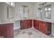 Bathroom featuring double vanities with wood cabinets, tiled floors, and large mirrors at 345 Phillips Dr, Fayetteville, GA 30214