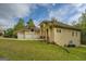 Exterior of home with attached three car garage and well-manicured lawn at 345 Phillips Dr, Fayetteville, GA 30214
