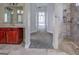 Open hallway view to the shower, the vanity, and a view to a large living room at 345 Phillips Dr, Fayetteville, GA 30214