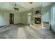 Spacious living room featuring a fireplace, carpet, tray ceilings and view of back yard at 345 Phillips Dr, Fayetteville, GA 30214